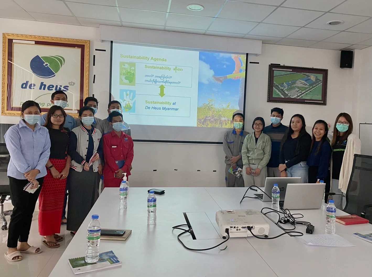 a group of people are discussing about sustainability in a meeting room